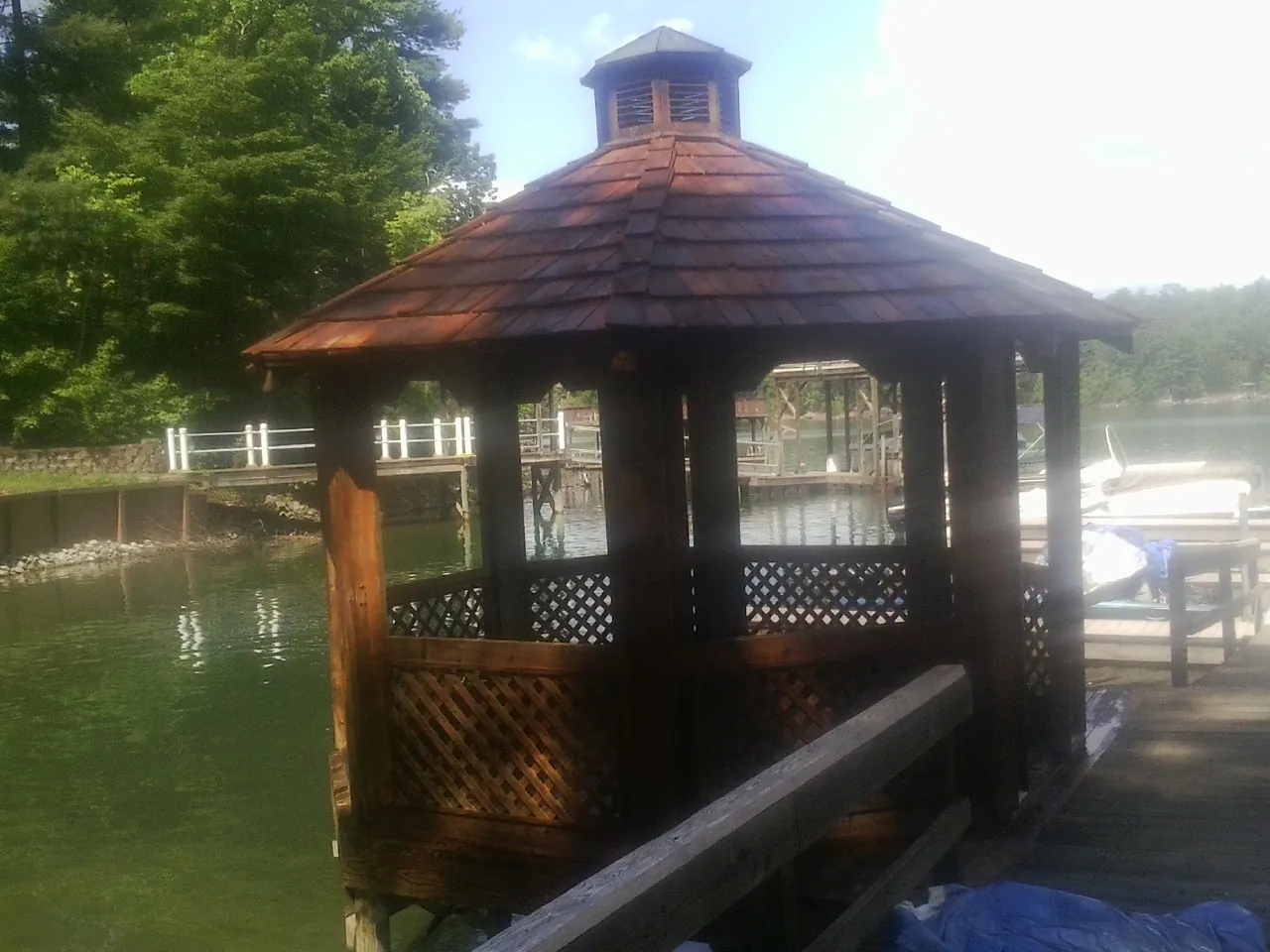 Cedar shake gazebo roof rebuilt on a lake dock in Great Falls